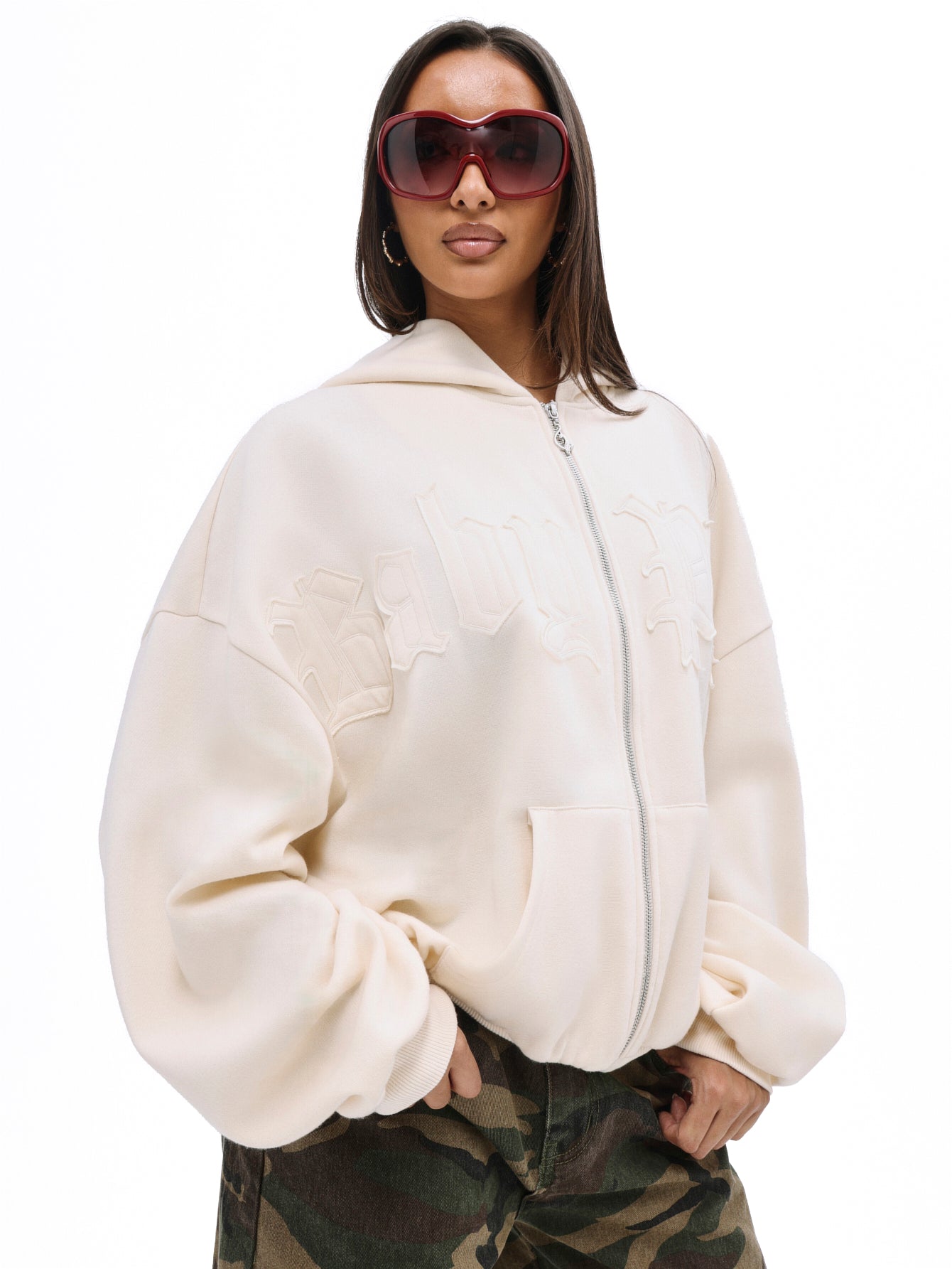 Zip up sweatshirt with gothic applique, cream zip-front hoodie with tonal gothic lettering, on-model front view
