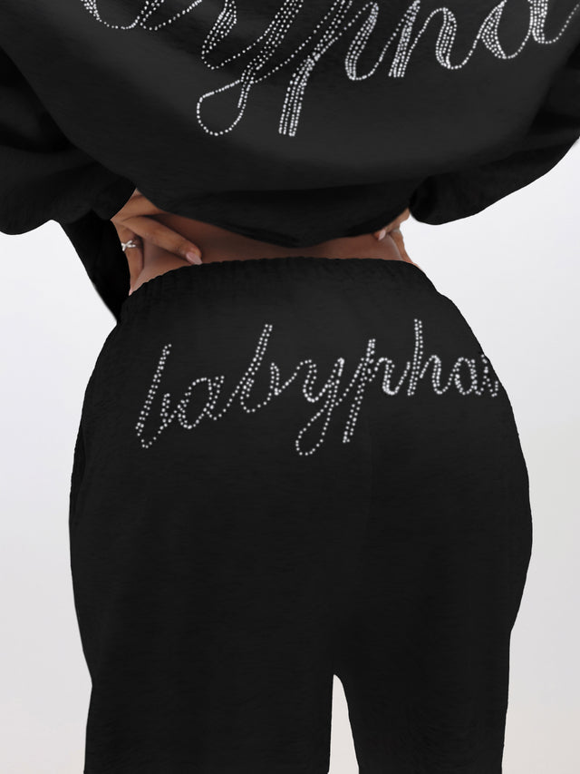 Sweatpants With Rhinestones, black wide-leg sweats with rhinestone script at back waist, back view