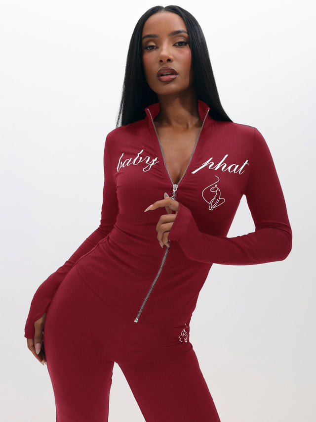 Long Sleeve High Neck Zip Up Top, burgundy fitted silhouette with front zipper and script logo, on-model styling view