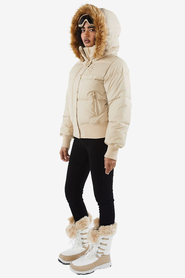 Baby Phat reissue OG puffer jacket in sand is a tan beige jacket that features a faux fur trim hood, cat logo detailing on the front and back, gold buttons, and a cat zipper pull.