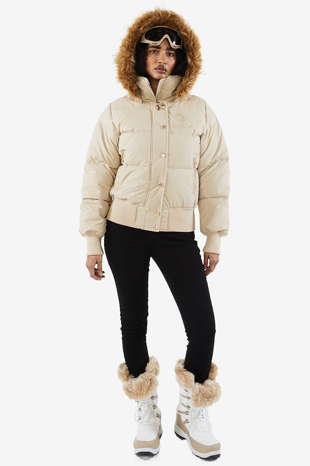 Baby Phat reissue OG puffer jacket in sand is a tan beige jacket that features a faux fur trim hood, cat logo detailing on the front and back, gold buttons, and a cat zipper pull.