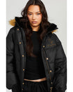 Model shown wearing black puffer jacket. Coat features natural faux fur trimmed detachable hood and Baby Phat script logo on front chest and oversized cat logo on the back. Jacket also features gold cat logo zipper pulls on the front pockets and center front.