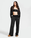 Standard sized model shown wearing black velour sweatpants. Pants feature a wide leg, open bottom fit with a rhinestone Baby Phat cat logo on the wearer's left upper thigh. Pants feature pockets and an elastic waistband with a drawstring tie.