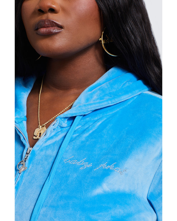 Detail shot of script Baby Phat rhinestone logo detail.