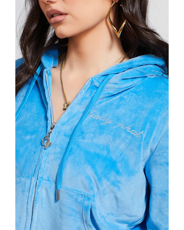 Detail shot of script rhinestone Baby Phat logo on wearer's left chest.