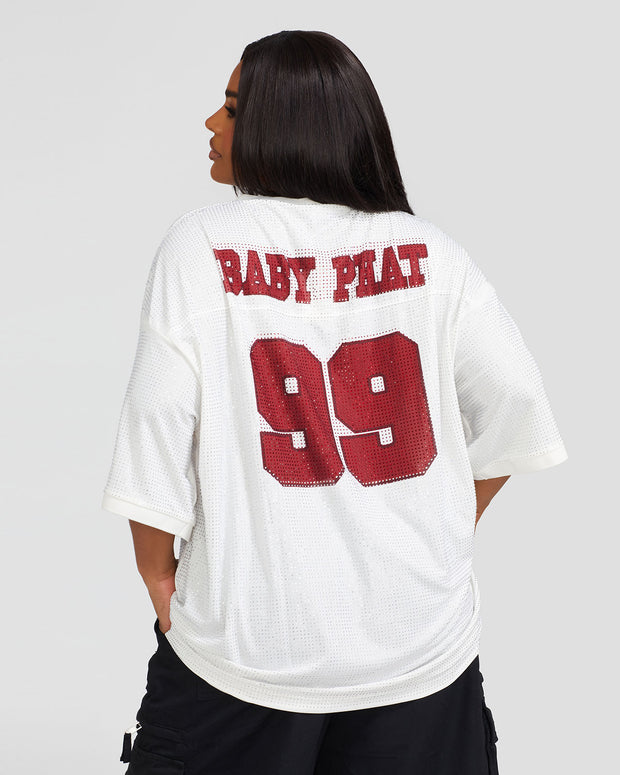 Back view image shows plus sized model wearing off white oversized jersey with clear rhinestones all over. Jersey features burgundy 99 logo large at center back with burgundy rhinestones. Jersey features large burgundy Baby Phat varsity logo across upper back.