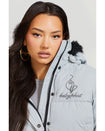 Model shown wearing light grey smoke puffer jacket. Coat features black faux fur detachable hood and Baby Phat script logo on front chest and oversized cat logo on the back. Jacket also features gold cat logo zipper pulls on the front pockets and center front.