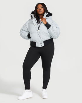 Smoke Puffer, plus-size light grey puffer styled with black leggings, front full-body view