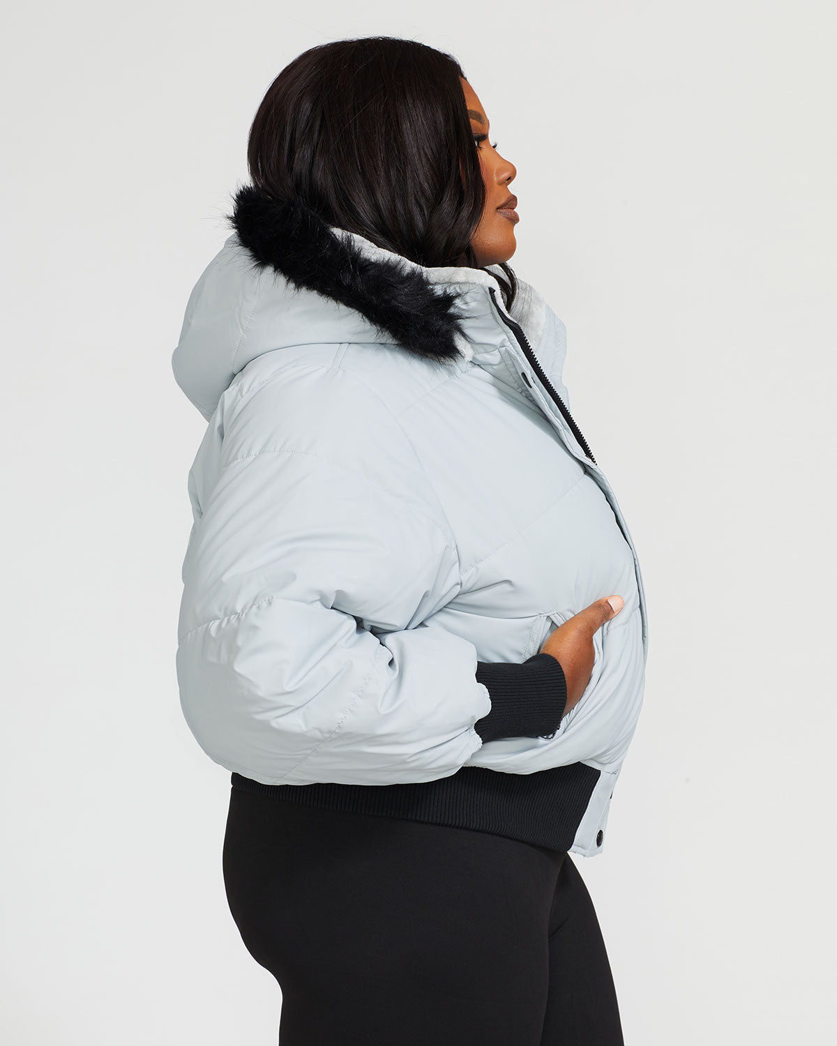 Plus sized model shown wearing light grey smoke puffer jacket. Coat features black faux fur detachable hood and Baby Phat script logo on front chest and oversized cat logo on the back. Jacket also features gold cat logo zipper pulls on the front pockets and center front.