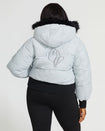 Plus sized model shown wearing light grey smoke puffer jacket. Coat features black faux fur detachable hood and Baby Phat script logo on front chest and oversized cat logo on the back. Jacket also features gold cat logo zipper pulls on the front pockets and center front.