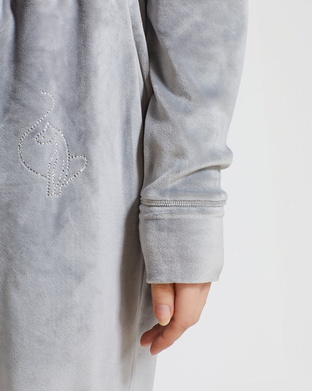 Detail image of rhinestone Baby Phat cat logo on wearer's left upper thigh.