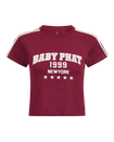 Baby Phat heritage t-shirt in burgundy features graphic cream logo with year 1999, New York, and stars. Sleeve features cream stripes.