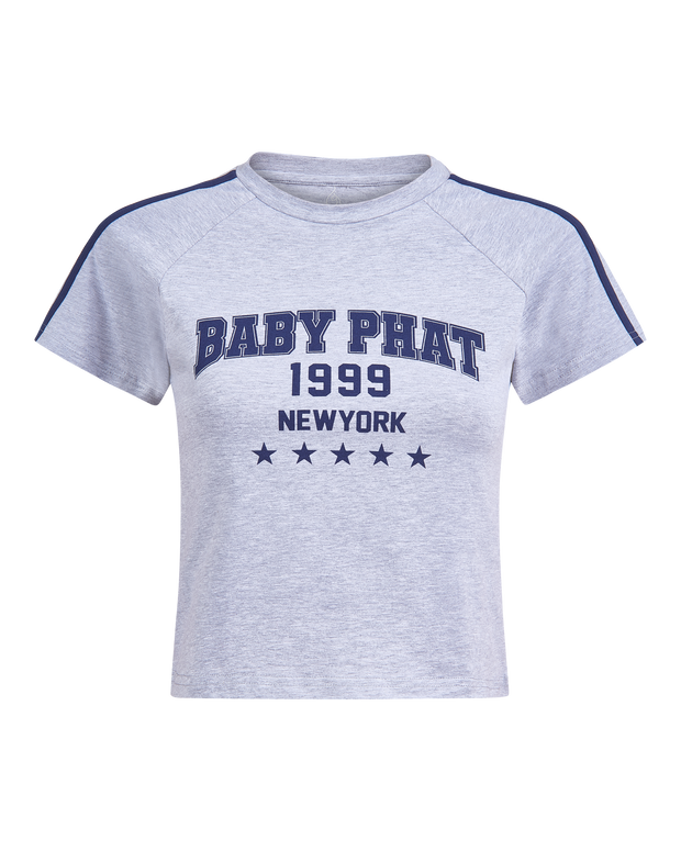 Baby Phat heritage t-shirt in grey features graphic navy blue logo with year 1999, New York, and stars. Sleeve features navy blue stripes.