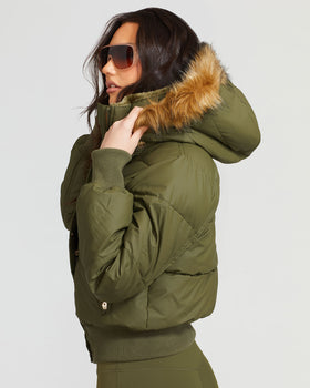 OLIVE PUFFER, olive puffer with raised fur-trim hood, side view