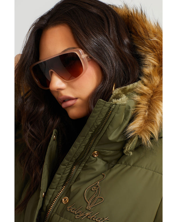 Model shown wearing olive green puffer jacket. Coat features faux fur detachable hood and Baby Phat script logo on front chest and oversized cat logo on the back. Jacket also features gold cat logo zipper pulls on the front pockets and center front.