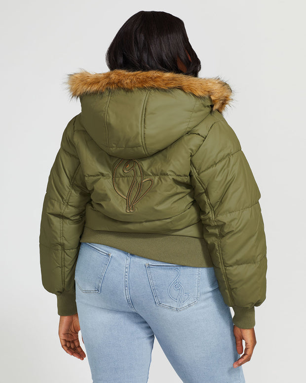 Plus sized model shown wearing olive green puffer jacket. Coat features faux fur detachable hood and Baby Phat script logo on front chest and oversized cat logo on the back. Jacket also features gold cat logo zipper pulls on the front pockets and center front.