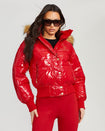 Model shown wearing glossy red puffer jacket. Coat features natural faux fur trimmed detachable hood and Baby Phat script logo on front chest and oversized cat logo on the back. Jacket also features gold cat logo zipper pulls on the front pockets and center front.