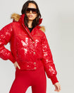 Model shown wearing glossy red puffer jacket. Coat features natural faux fur trimmed detachable hood and Baby Phat script logo on front chest and oversized cat logo on the back. Jacket also features gold cat logo zipper pulls on the front pockets and center front.