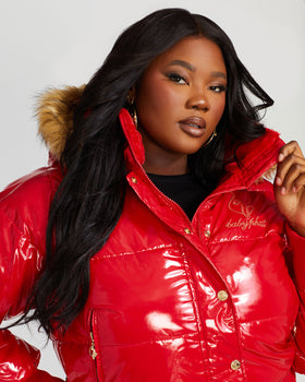 Chili Puffer, glossy red jacket showing chest embroidery and zipper, close-up detail