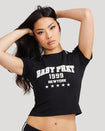 Standard sized model shown wearing black baby tee shirt with Baby Phat logo, New York, 1999, and stars on the center front. 