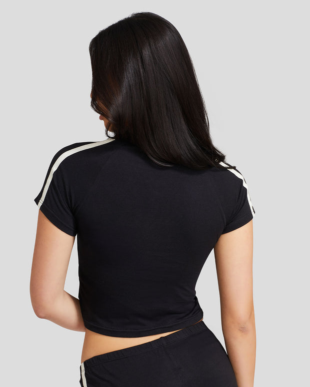 Standard sized model shown from the back wearing black baby tee shirt.