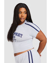 Plus sized model shown wearing heather grey baby tee shirt with navy blue Baby Phat logo, New York, 1999, and stars on the center front. Shirt features navy blue stripes on the shoulder. Model is also wearing matching micro shorts with side stripes and a 99 cat logo.