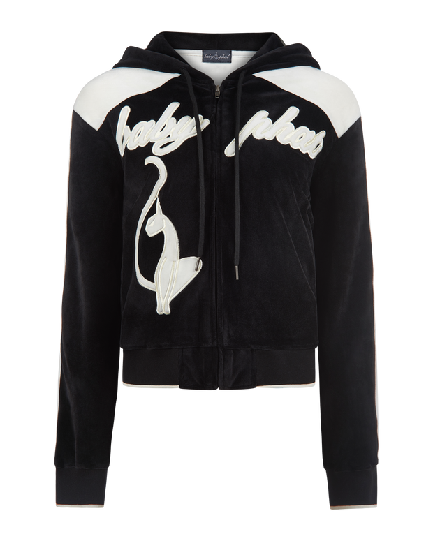 Velour zip up sweatshirt in black features cream color blocking. Baby Phat script logo across the chest. Oversized cat logo on the front of jacket. Back of jacket features additional cat logo.