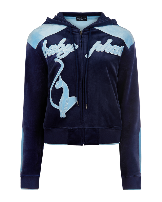 Velour zip up sweatshirt in navy features light blue color blocking. Baby Phat script logo across the chest. Oversized cat logo on the front of jacket. Back of jacket features additional cat logo.