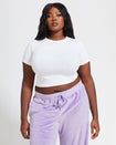 Plus sized model shown wearing white baby tee t-shirt with rhinestone Baby Phat cat logo on center front. 
